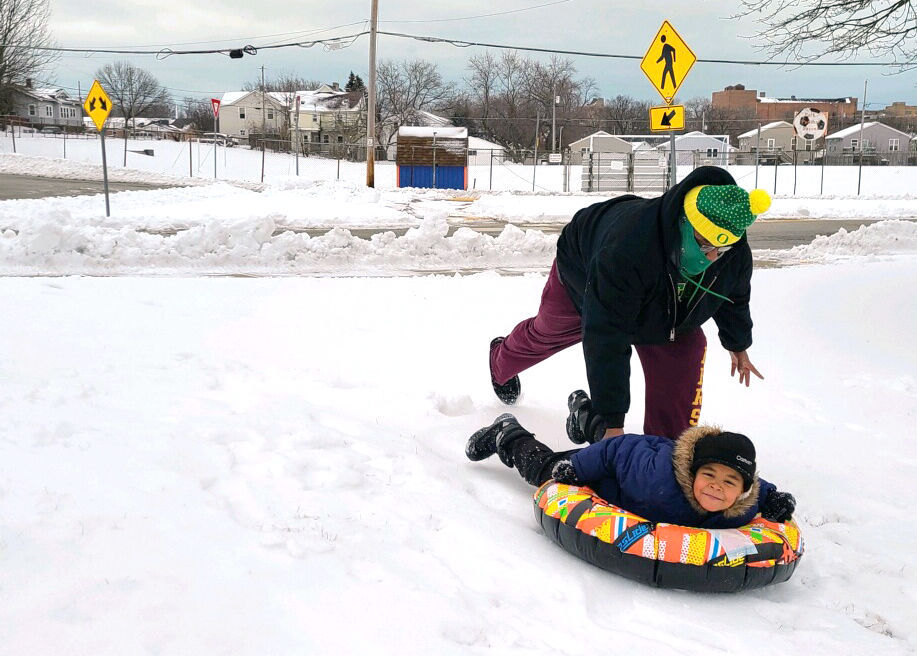Smiling and sledding